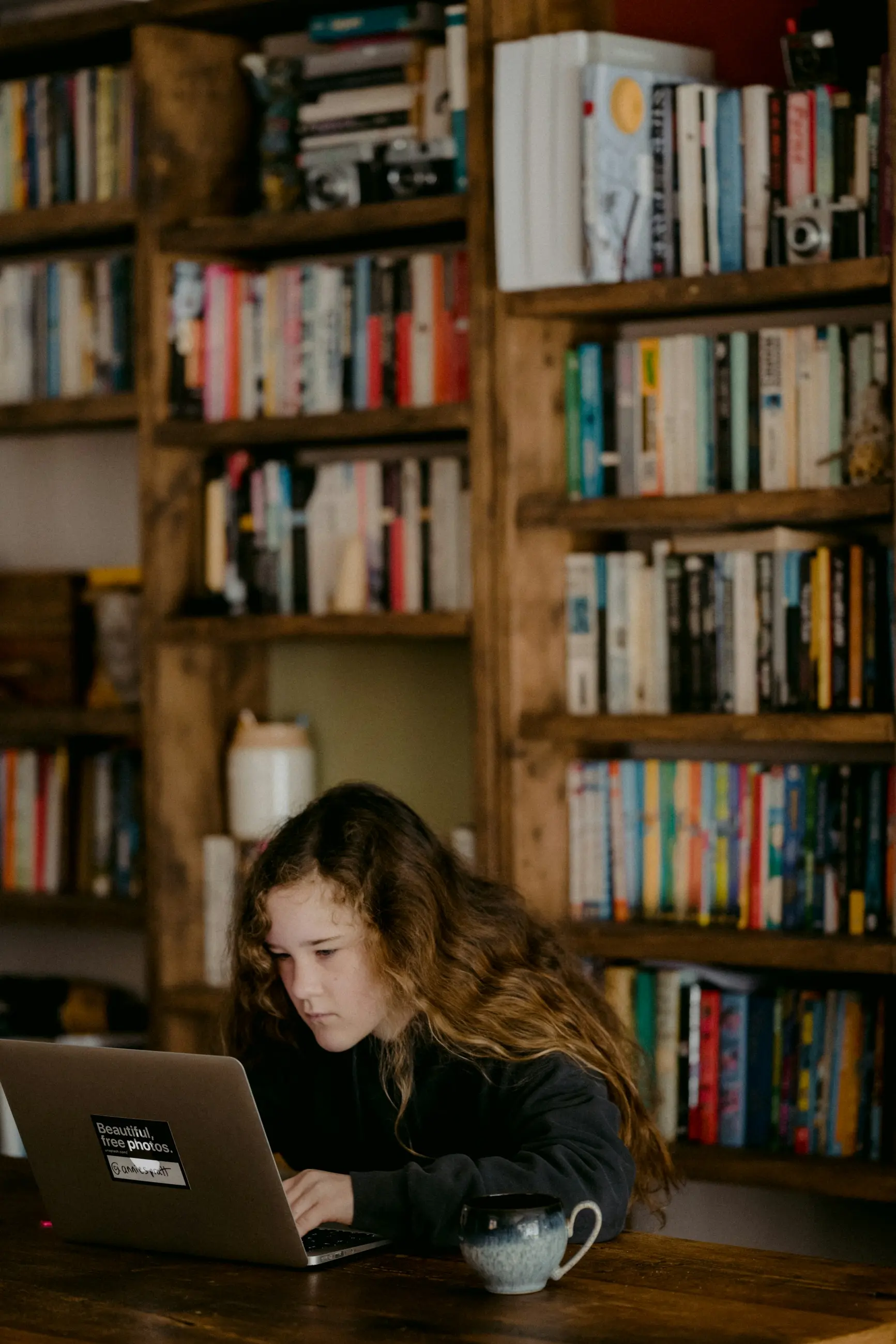 Young person completing schoolwork at a table